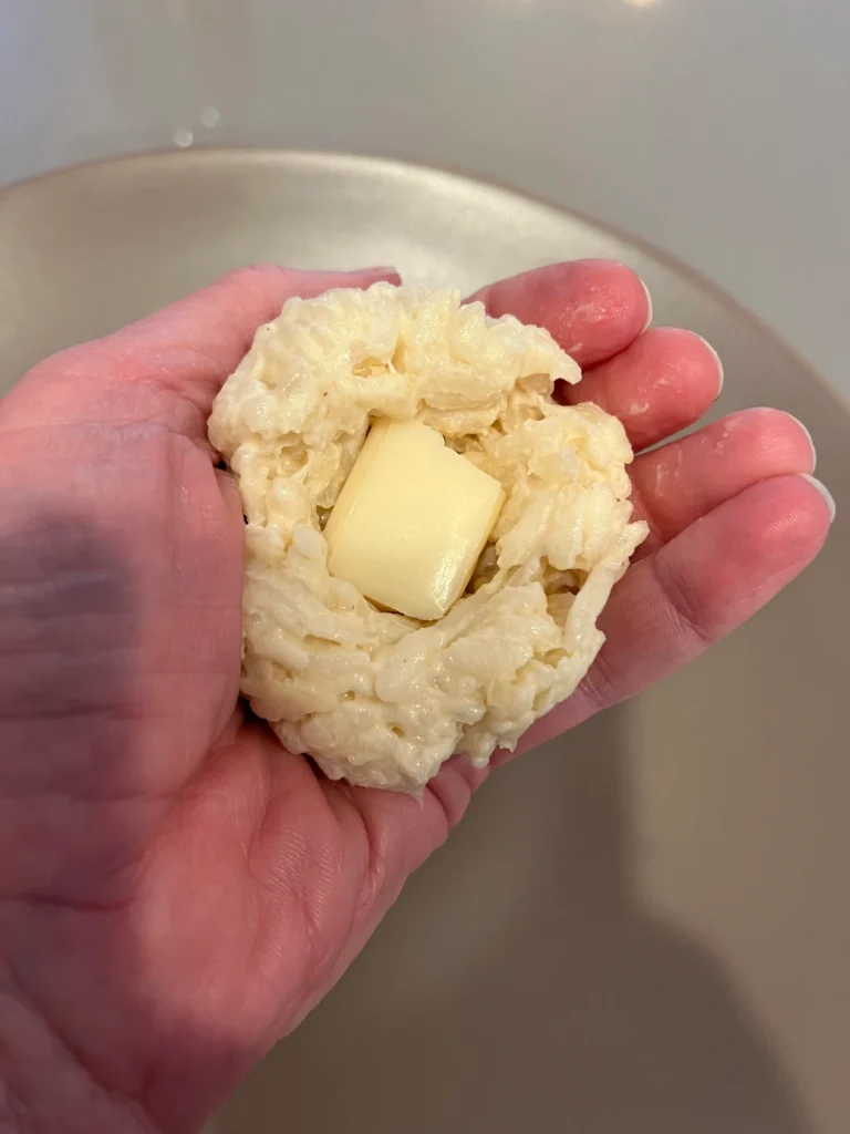 a ball of risotto with cheese in center