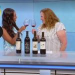 clinking wine glasses on the set of KSEE TV